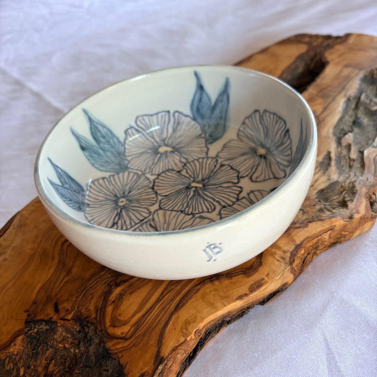 Ceramic bowl with floral design on a wooden surface