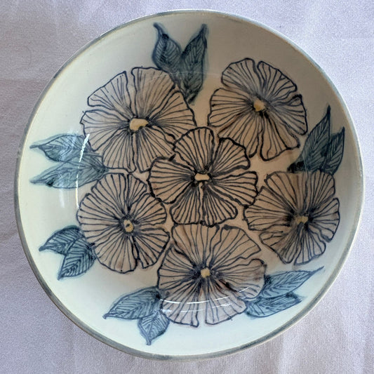 Ceramic plate with floral design on a white background
