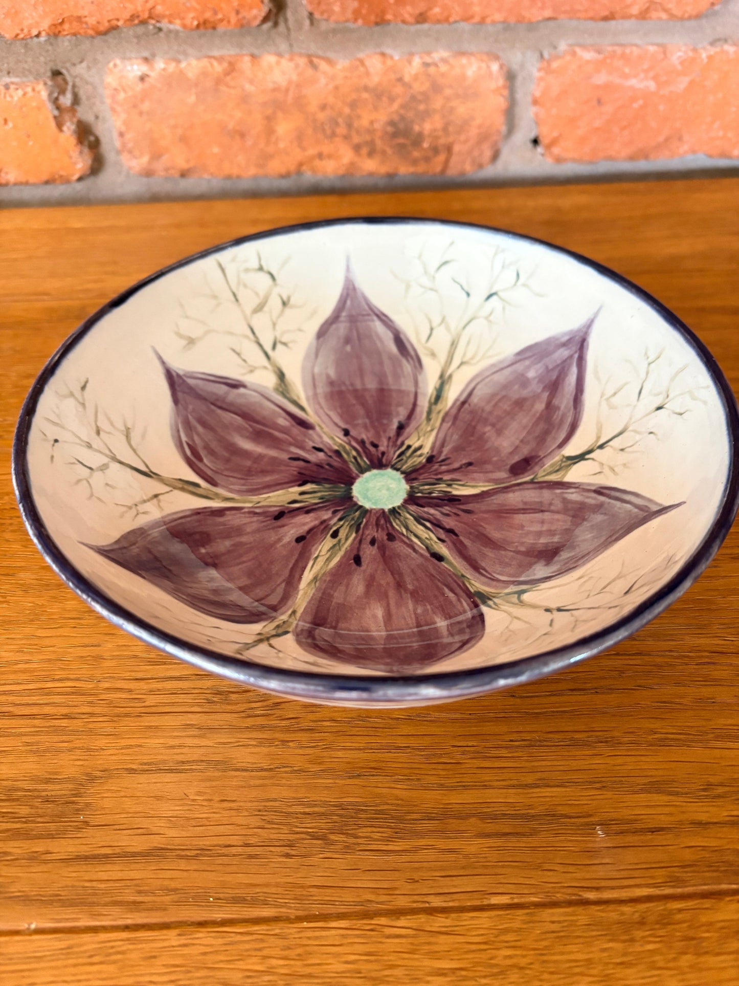 Hand‑painted ceramic bowl featuring a Love‑in‑a‑Mist flower from the Petal & Earth Collection.