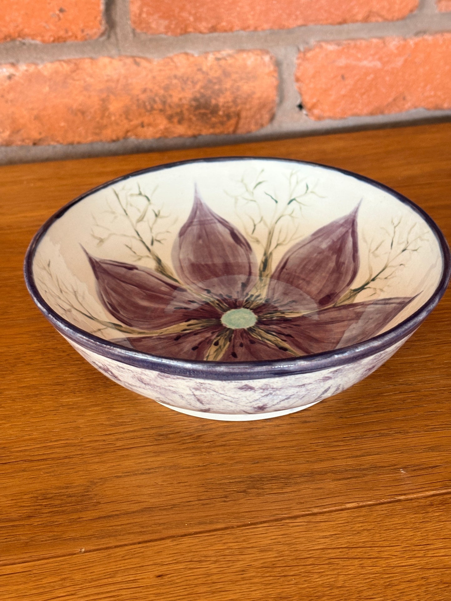 Hand‑painted ceramic bowl featuring a Love‑in‑a‑Mist flower from the Petal & Earth Collection.