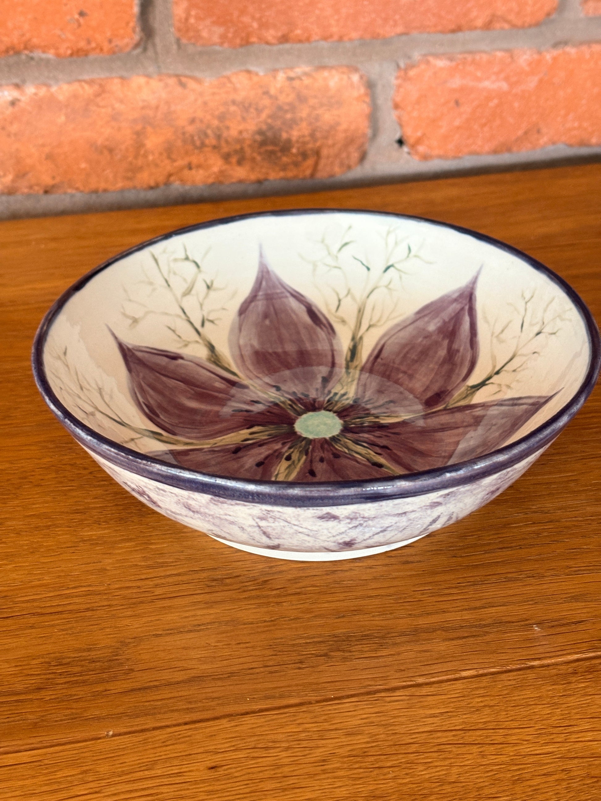 Hand‑painted ceramic bowl featuring a Love‑in‑a‑Mist flower from the Petal & Earth Collection.